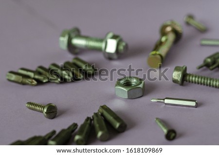 Nut, bolt, screw, bits for screwdriver.  Industrial subject background. Light background. Side view. Selective focus.