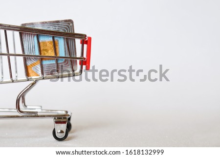 RFID tag in a supermarket trolley. Shoplifting Prevention. Goods security and alarm. Light background. Free space for an inscription. Picture for warning shoplifters.