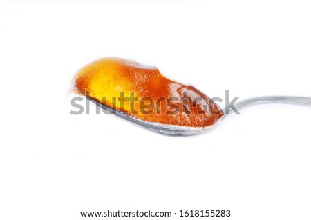 sweet yellow honey food in spoon isolated on white background