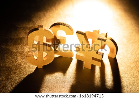 Major international currency unit symbols mixed on golden background