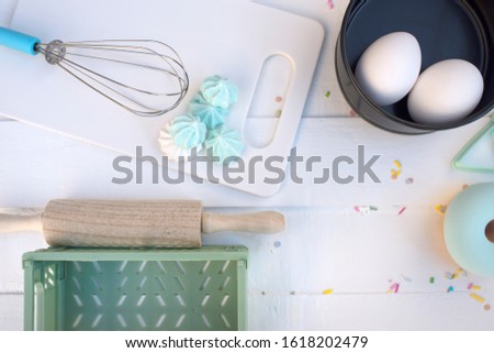 Flatlay Baking tools in a pastel mint blue on a white wooden table Easter brunch concept