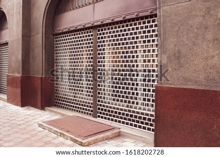 Closed shops.Concept of  lockdown, ban, end of trade.  Metal  protective grilles windows. window grill, facade, protected. 