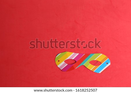 Party cardboard mask on colorful background