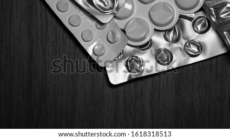 Tablets. Packaging from pills. The use of medicines. A fast-dissolving, effervescent tablet, allergy pill and antibiotics.Virus Diseases in Winter.Black and white.Medical and biological waste concept.