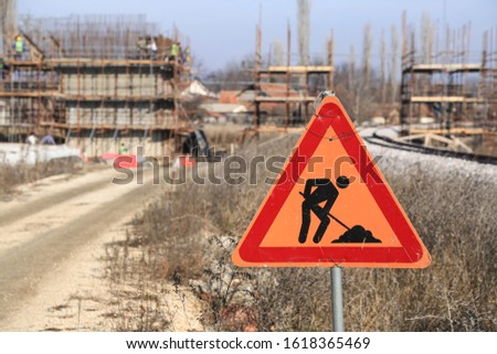 Road with Signs 
Construction Workers 
