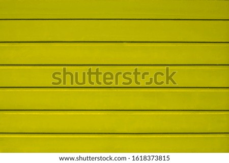 Photo of wooden boards painted in yellow, folded horizontally in the form of a continuous canvas. Great for background