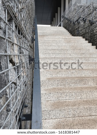 staircase rises up against the background of stones