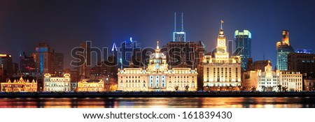 Shanghai historic architecture panorama at night lit by lights over Huangpu River