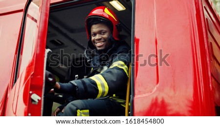 Firefighter portrait on duty. Portrait of african american Firefighter in protective suit.