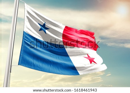 Panama national flag cloth fabric waving on the sky with beautiful sun light