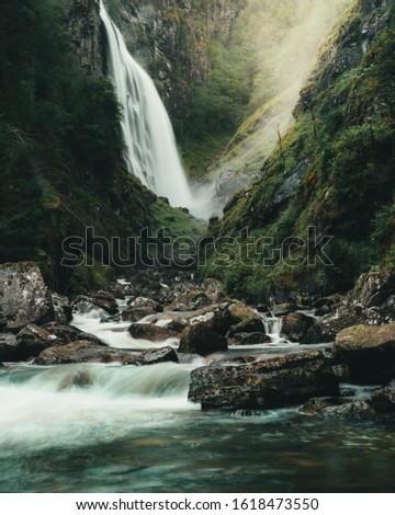 secret waterfall deep into the forest Royalty-Free Stock Photo #1618473550