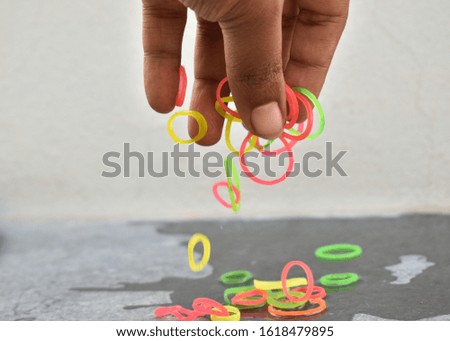 Picking rubber bands from a multi color rubber bands with fingers. Suitable picture for backgrounds and template use.