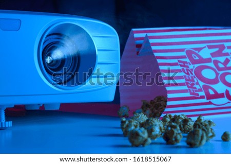Background and film. Watching films. Projector and popcorn