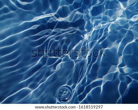 Reflection of sunlight to wave under deep sea water. Deep blue water texture for background