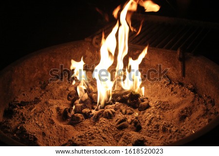 Close up on a fire pit in the woods while camping