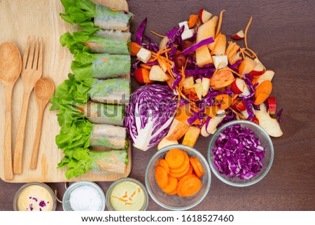delicious fruit salad in a clay brown dish on a cutting board with two dessert forks, mint leaves, on an old wooden table, close-up, top view