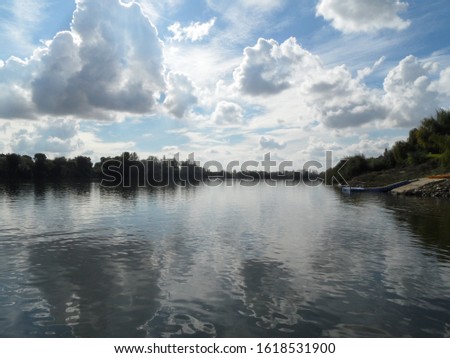 river landscape with clouds reflecting in the water