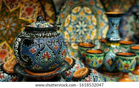 Ethnic Uzbek ceramic tableware. Decorative ceramic plates and cups with traditional uzbekistan ornament.