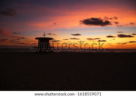 Miami South Beach beautiful sunrise with lifeguard station and colorful sky  