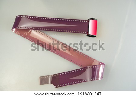Curved roll and film cassette lies on a light background. Cover. Web banner. Element for design.