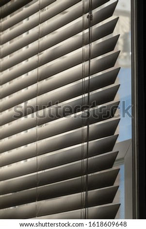 Blinds almost closed with the sun shining in. Royalty-Free Stock Photo #1618609648