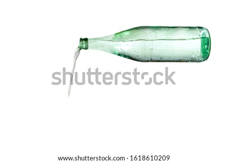 glass bottle that pours water isolated on a white background copy space