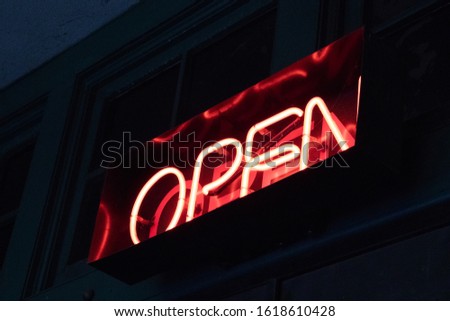 Red neon open sign on a building 