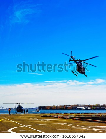 Helicopter landing at helipad. Skyline with Skyscrapers in Lower Manhattan, New York City, America USA. American architecture building. Metropolis NYC. Cityscape. Hudson, East River NY. Mixed media.