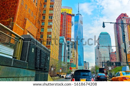 Car traffic on road and Skyline with Skyscrapers in Financial Center at Lower Manhattan New York City, America. USA. American building. Panorama of Metropolis NYC. Metropolitan Cityscape. Mixed media.