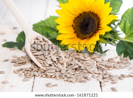 Fresh Sunflower Seeds (Macro Shot on wooden background) Royalty-Free Stock Photo #161871221