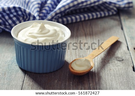 Greek yogurt in a ceramic bowl with spoons on wooden background Royalty-Free Stock Photo #161872427