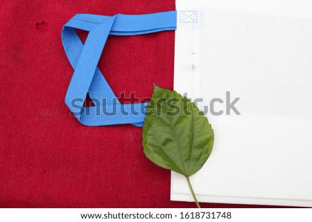 isolated green leaf, white bag with blue handle loop on dark red background. Gift & Grocery Bags. Reduce, Reuse, Recycle, save earth. World Environment Day 