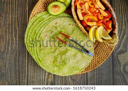 Spinach tortillas with fajita, lemon and avocado. Mexican cuisine.