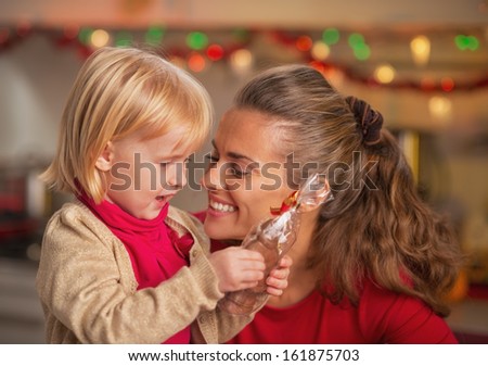 Portrait of happy mother and baby with chocolate santa