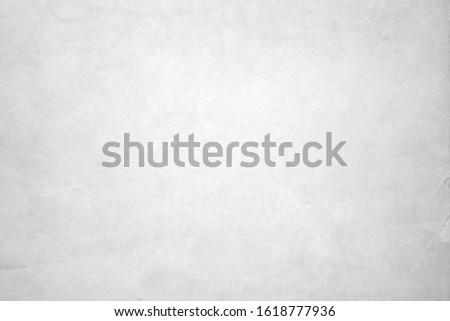           A grey white coloured textured wall  background that is empty.            