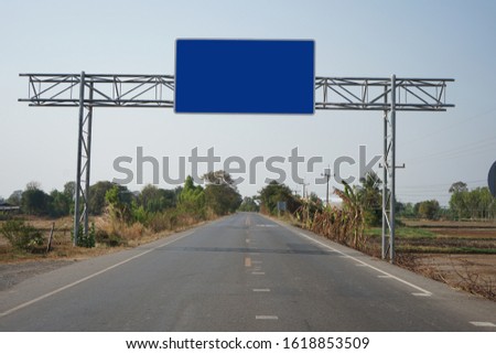 Blue traffic sign across the road