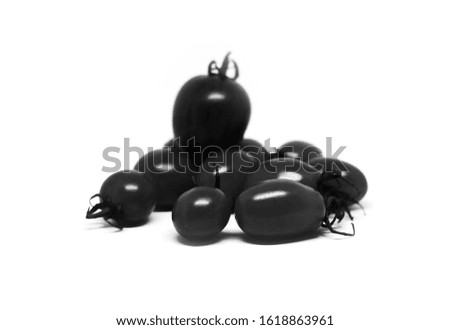Black cherry tomatoes isolated on white background.