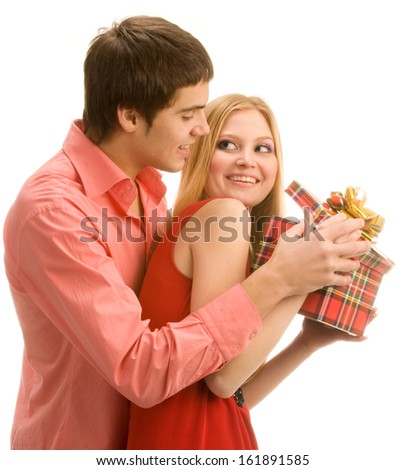 Guy is trying to look into girl's gift box, isolated on white background
