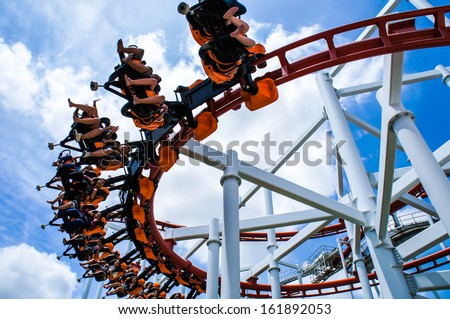 Rollercoaster ride with sky at theme park Royalty-Free Stock Photo #161892053