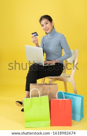 Women holding a credit card to make purchases online.