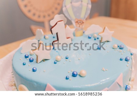 A beautiful blue cake with the number 1 at the top. Beautiful blue cake for baby for 1 year.