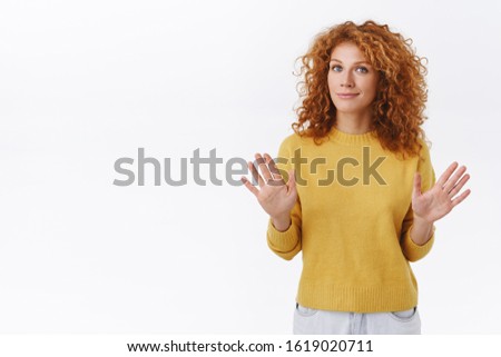 Wow hold one, calm down. Relaxed cute redhead curly woman try lower tension, raise arms in stop, its okay gesture, smiling, telling eveyrything alright, convince someone thats enough