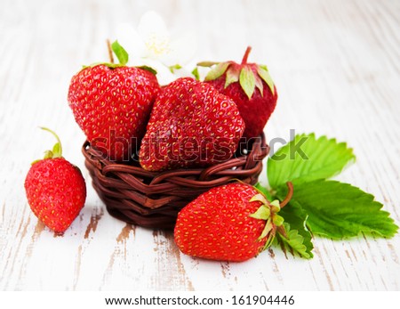fresh strawberries in a basket on a  wooden table