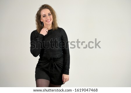 Concept woman smiling talking. Portrait of a model girl with excellent makeup with short hair and good teeth in the studio on a white background.