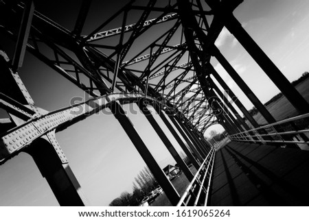 Classic steel truss bridge in black and white Royalty-Free Stock Photo #1619065264