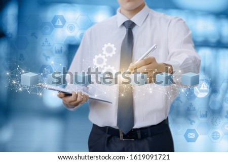 The businessman chooses the box with the product on blurred background.
