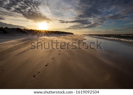 A beach after a storm during a windy evening in the Slowinski Na