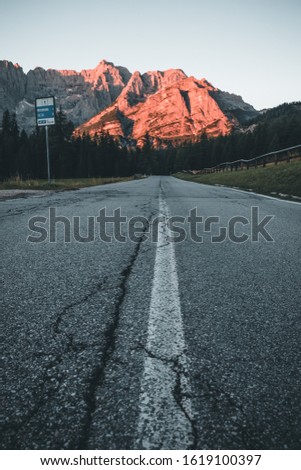 sunset at the peaks, road in dolomites