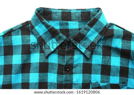Plaid shirt close up of checkered light blue top. Tartan squared pattern on casual clothes isolated on empty white background, classic stylish blue and black flannel outfit for men and women 