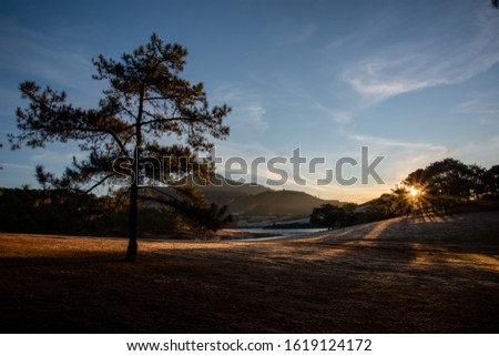 bright sunbeams on the beauty meadow at plateau with the warm, peaceful and blue sky. Best photo use for advertise travel, ideas design and more